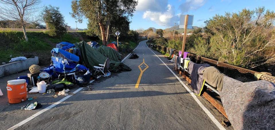 Belongings from homeless people line the Bob Jones Trail at Los Osos Valley Road in January 2023 after high water from storms made the area uninhabitable. Laura Dickinson/ldickinson@thetribunenews.com