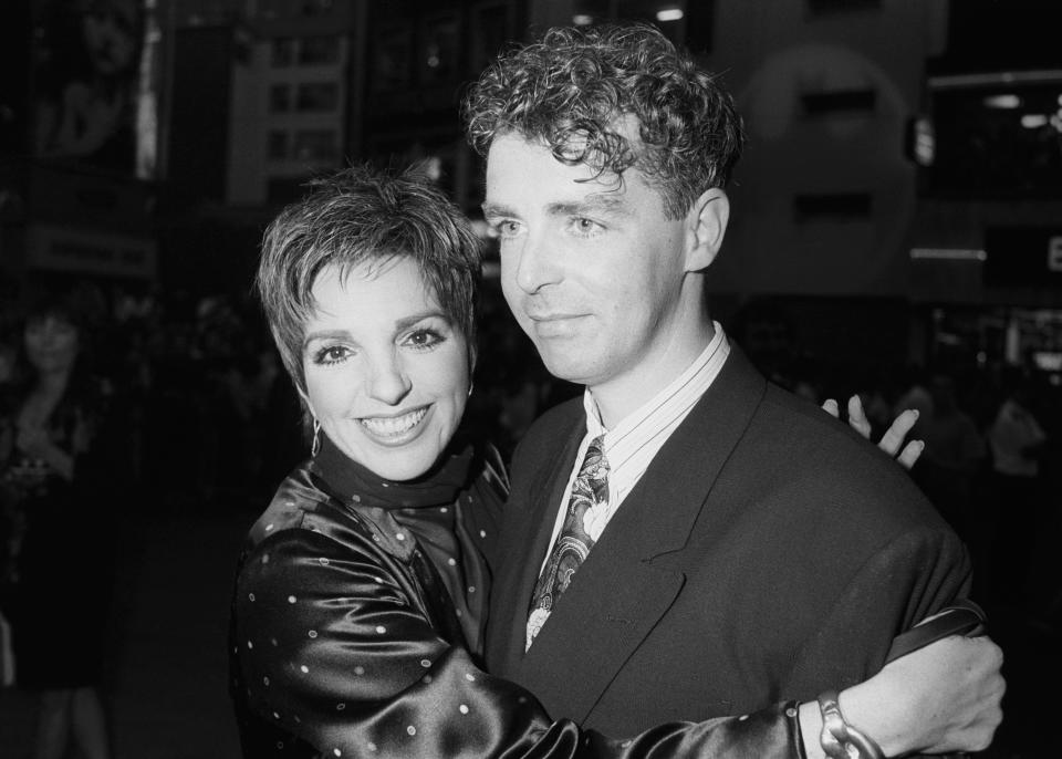 <p>Singer and actress Liza Minnello (l) hugging Neil Tennant from the band 'Pet Shop Boys' as they attend the Premiere of Hollywood blockbuster 'Batman' at the Warner West End Cinema, Leicester Square, London in 1989. (PA via Getty Images)</p> 