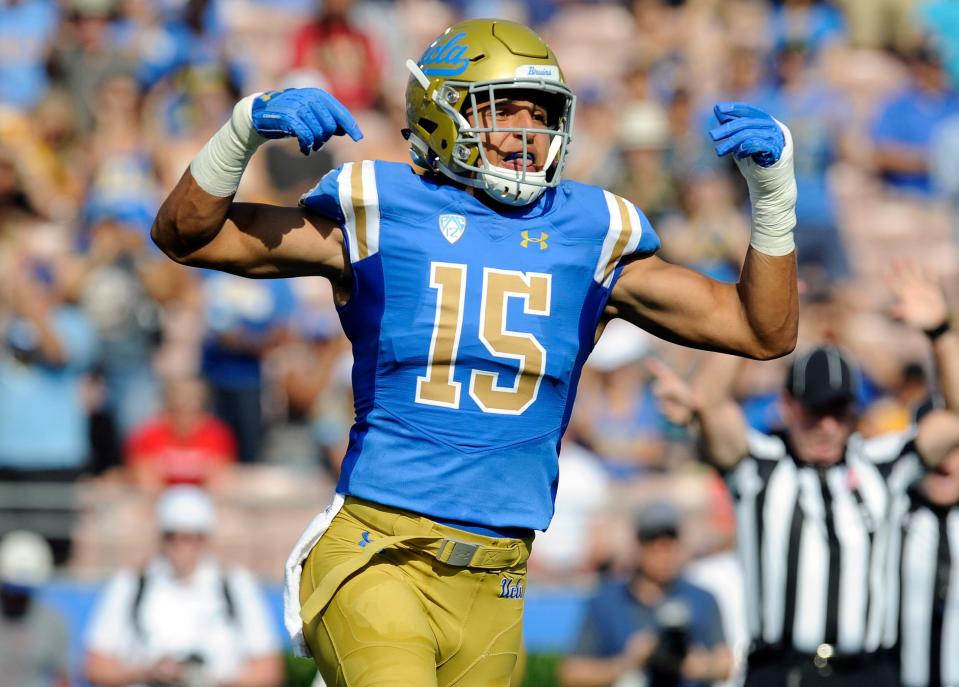 In this September 1, 2018 photo, UCLA Bruins linebacker Jaelan Phillips (15) reacts after a defensive play against the Cincinnati Bearcats during the first half at the Rose Bowl.