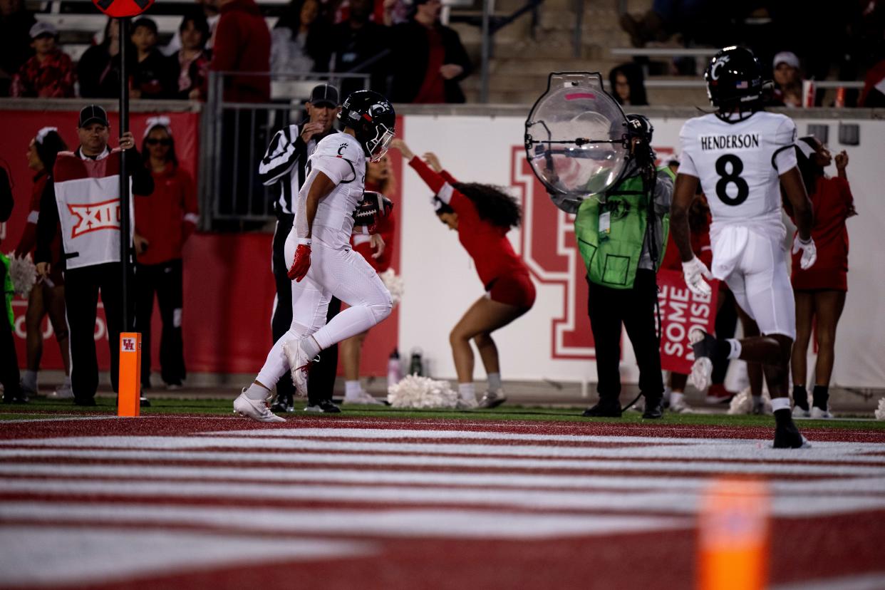 Cincinnati Bearcats running back Ryan Montgomery (22) scores a touchdown in the first quarter of the NCAA football game between the Cincinnati Bearcats and the Houston Cougars TDECU Stadium in Houston, Texas, on Saturday, Nov. 11, 2023.