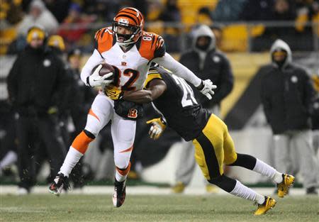 Dec 15, 2013; Pittsburgh, PA, USA; Cincinnati Bengals wide receiver Marvin Jones (82) runs the ball past Pittsburgh Steelers safety Will Allen (20) during the second half at Heinz Field. The Steelers won 30-20. Mandatory Credit: Jason Bridge-USA TODAY Sports