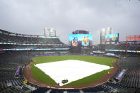 A tarp covers the infield before a baseball game between the New York Mets and the Detroit Tigers on Tuesday, April 2, 2024, in New York. The start was delayed by rain. (AP Photo/Frank Franklin II)