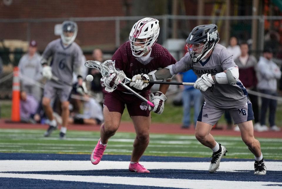 La Salle's Anthony DiCenso, left, battles Moses Brown's Casey Lambert after a faceoff during a game last month.