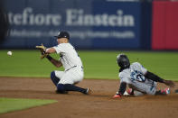 Miami Marlins' Jazz Chisholm Jr., right, steals second base as New York Yankees shortstop Anthony Volpe waits for the throw during the third inning of a baseball game at Yankee Stadium on Wednesday, April 10, 2024, in New York. (AP Photo/Seth Wenig)