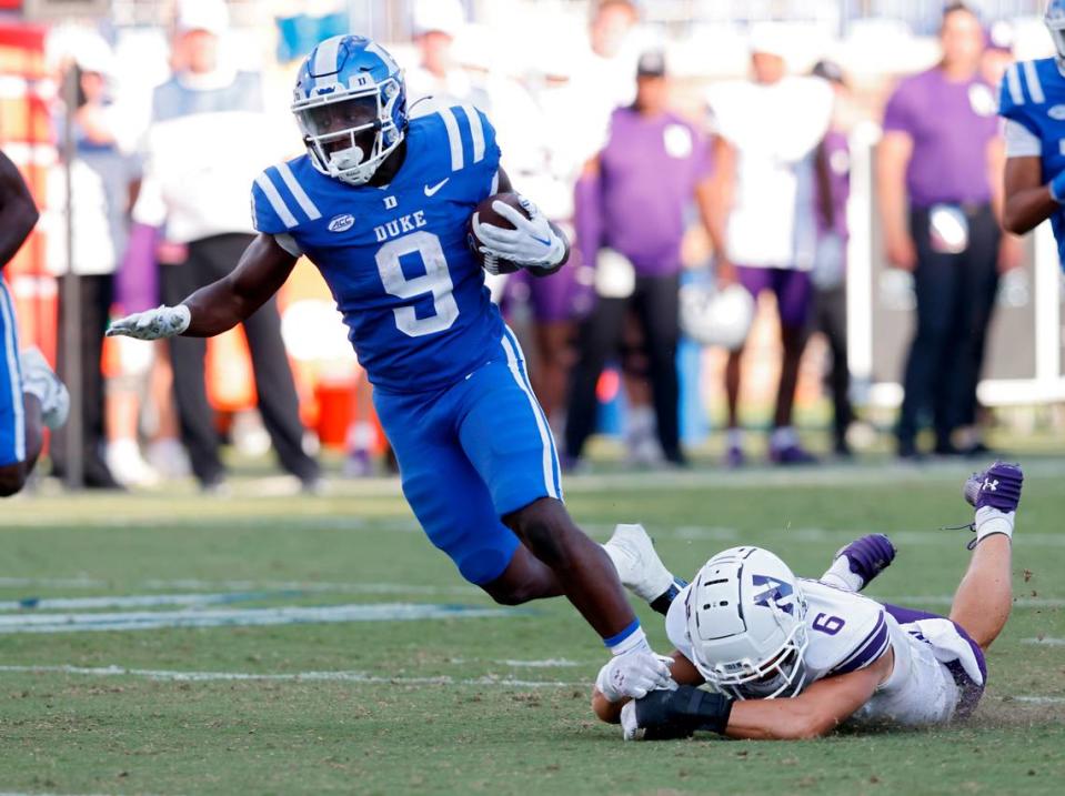 Duke’s Jaquez Moore runs the ball under pressure from Northwestern’s Robert Fitzgerald during the second half of the Blue Devils’ 38-14 win on Saturday, Sept. 16, 2023, at Wallace Wade Stadium in Durham, N.C. Kaitlin McKeown/kmckeown@newsobserver.com