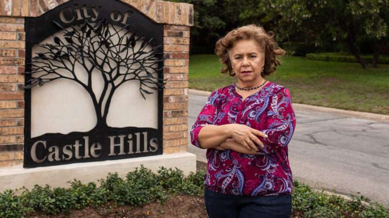 Sylvia Gonzalez outside of the Castle Hills, Texas sign