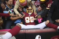 Washington Redskins tight end Vernon Davis (85) celebrates with fans after this touchdown catch during the first half of an NFL football game against the Carolina Panthers, Sunday, Oct. 14, 2018, in Landover, Md. (AP Photo/Pablo Martinez Monsivais)