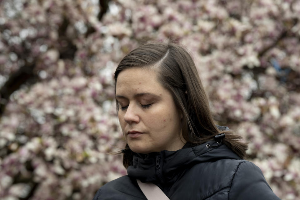 A woman joins others gathered in front of the Patterson Park Observatory to participate in a prayer circle in honor of the victims of the collapse of the Francis Scott Key Bridge, in Baltimore, Thursday, March 28, 2024. The prayer circle was hosted by Redemption City Church. (Kaitlin Newman/The Baltimore Banner via AP)