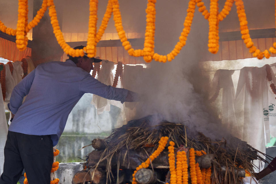 Partner Jim Morrison performs rituals during the funeral of famed American extreme skier Hilaree Nelson in Kathmandu, Nepal, Sunday, Oct.2, 2022. Nelson had died last week on Mount Manaslu while coming down from the top of the summit the 8,163-meter (26,775-foot) world's eighth-highest mountain. (AP Photo/Niranjan Shrestha)