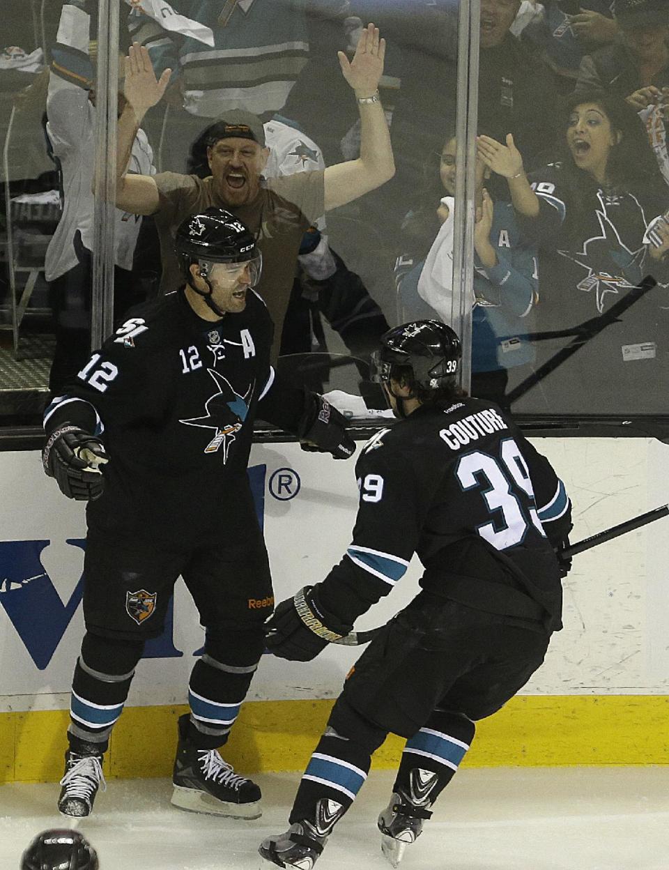 San Jose Sharks' Patrick Marleau, left, and Logan Couture celebrate Marleau's goal against the Los Angeles Kings during the third period of Game 2 of an NHL hockey first-round playoff series Sunday, April 20, 2014, in San Jose, Calif. The Sharks won, 7-2. (AP Photo/Ben Margot)