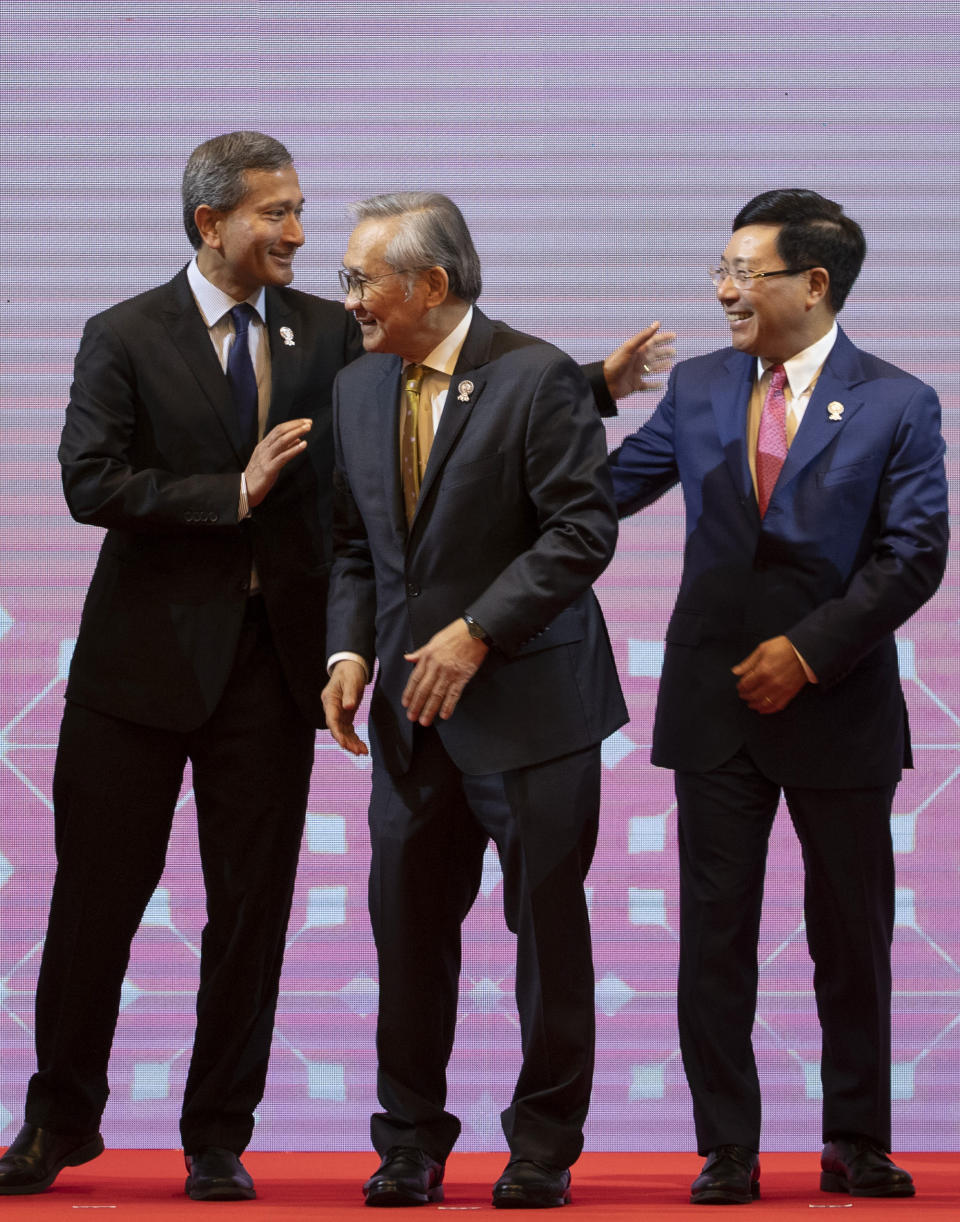 From left, Singapore Foreign Minister Vivian Balakrishnan, Thailand Foreign Minister Don Pramudwinai, and Vietnam Foreign Minister Pham Binh Minh greet each other after posing for a group photo during the Association of Southeast Asian Nations (ASEAN) Foreign Ministers' meeting in Bangkok, Thailand, Saturday, June 22, 2019. (AP Photo/Gemunu Amarasinghe)