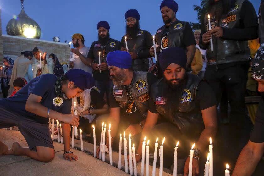 Oak Creek, WI - August 05: Members of Sikh Motorcycle Club travelled cross-country from Stockton light candles at candlelight vigil held to commemorate the 10th. anniversary of mass shooting at Sikh Temple of Wisconsin on Friday, Aug. 5, 2022 in Oak Creek, WI. (Irfan Khan / Los Angeles Times)