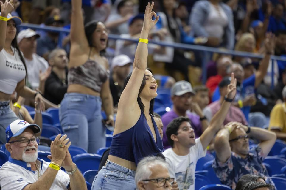 Bayamón Vaqueros cheer during a basketball game against the Guaynabo Mets at the Ruben Rodríguez Coliseum in Bayamón, Puerto Rico, Monday, July 1, 2024. Puerto Rico’s professional basketball league is experiencing a renaissance thanks to reggaeton stars like Bad Bunny, Ozuna and Anuel AA, who are stepping into the financial game, buying local teams and helping to stack up a loyal fan base. (AP Photo/Alejandro Granadillo)