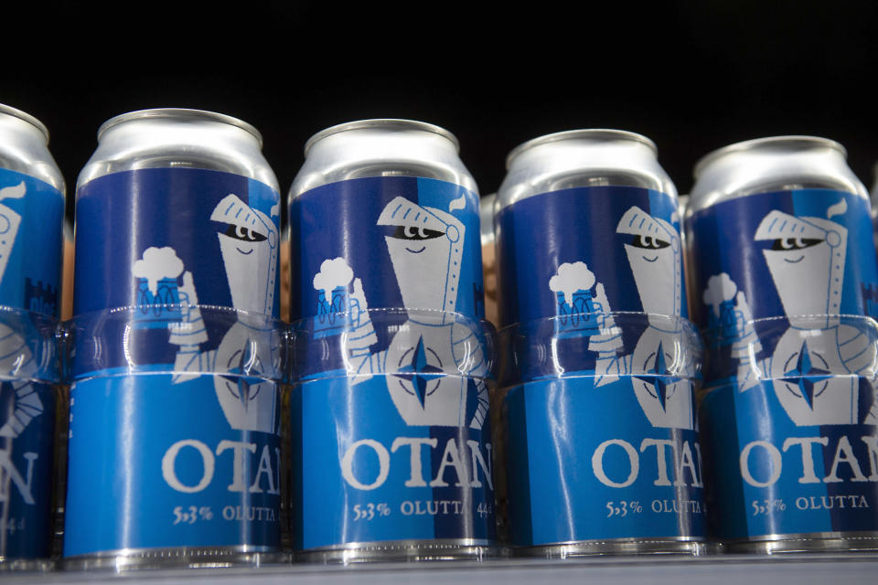 Beer cans with writing OTAN inspired by the North Atlantic Treaty Organization (NATO) logo by Olaf Brewing Company are displayed in Savonlinna, eastern Finland, Tuesday, May 17, 2022. Sweden on Tuesday signed a formal request to join NATO, a day after the country announced it would seek membership in the 30-member military alliance. In neighboring Finland, lawmakers are expected later in the day to formally endorse Finnish leaders’ decision also to join. The moves by the two Nordic countries, ending Sweden’s more than 200 years of military nonalignment and Finland’s nonalignment after World War II, have provoked the ire of the Kremlin. (Soila Puurtinen/Lehtikuva via AP)