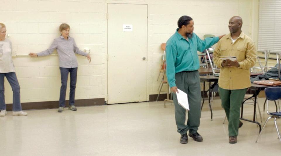 Michael Rhynes, right, speaks with Kenneth Brown, left, in rehearsals for the Phoenix Players Theatre Group's performance of "Maximum Will" in 2012 inside Auburn Correctional Facility.
