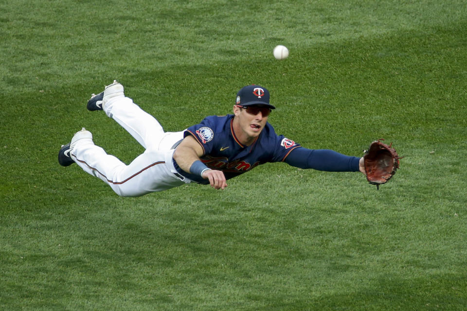 Minnesota Twins right fielder Brent Rooker dives for but misses a ball hit by Detroit Tigers' Jonathan Schoop for an RBI triple during the third inning of the second baseball game of a doubleheader Friday, Sept. 4, 2020, in Minneapolis. (AP Photo/Bruce Kluckhohn)
