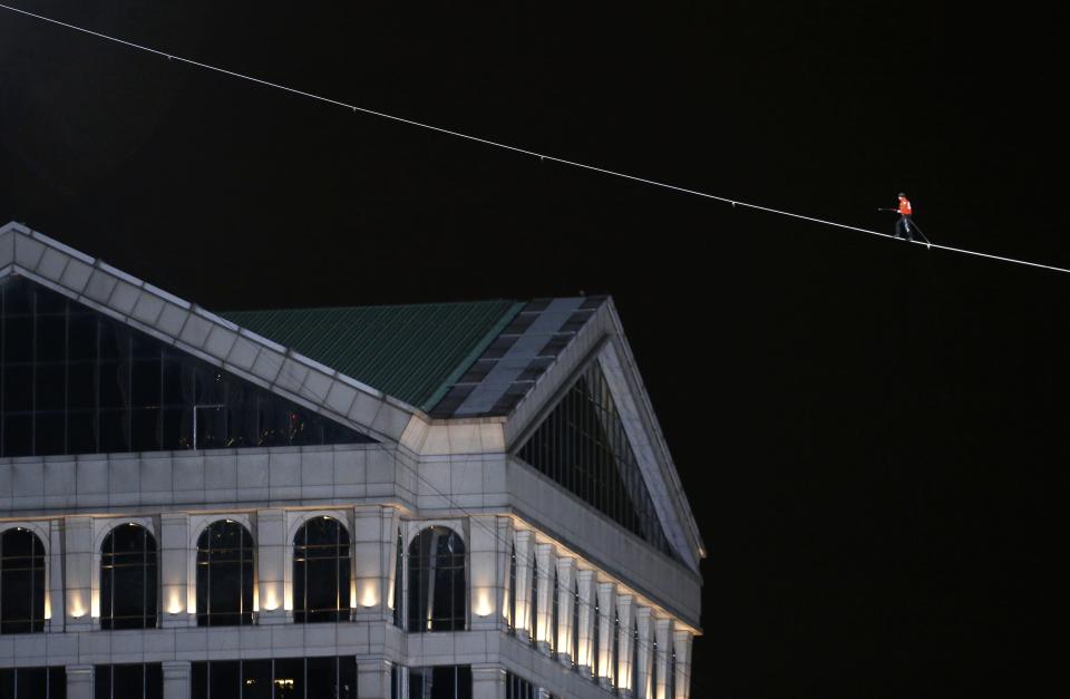 Daredevil Nik Wallenda walks along a tightrope between two skyscrapers suspended 500 feet (152.4 meters) above the Chicago River in Chicago, Illinois, November 2, 2014. (REUTERS/Jim Young)