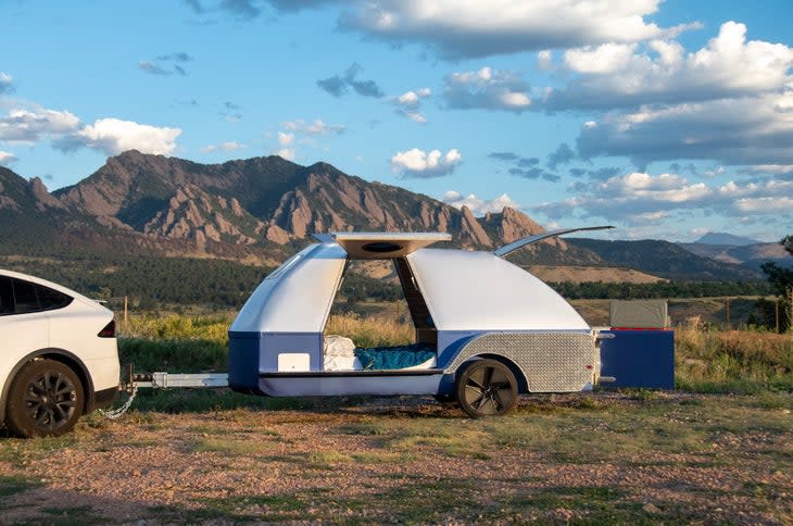 Electric trailer attached to a Tesla in the mountains