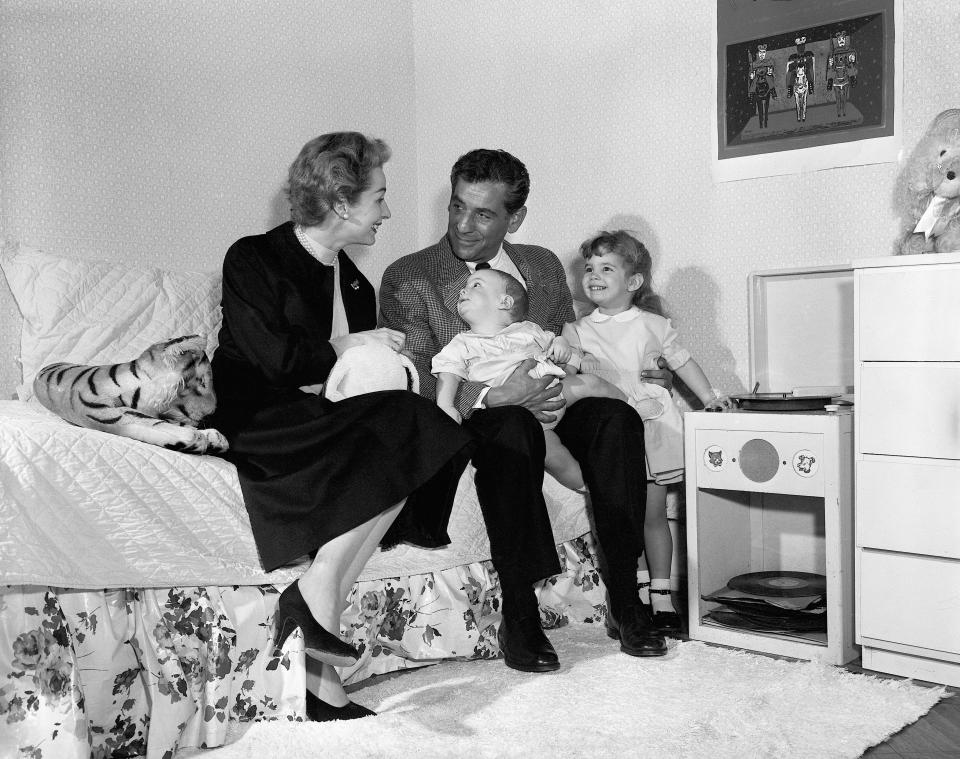 (Original Caption) 3/11/1956- Smiling happily at one another are Bernstein, his wife, actress Felicia Montealegre, and their two children, Jamie, 3, and Alexander Serge, 6 months.