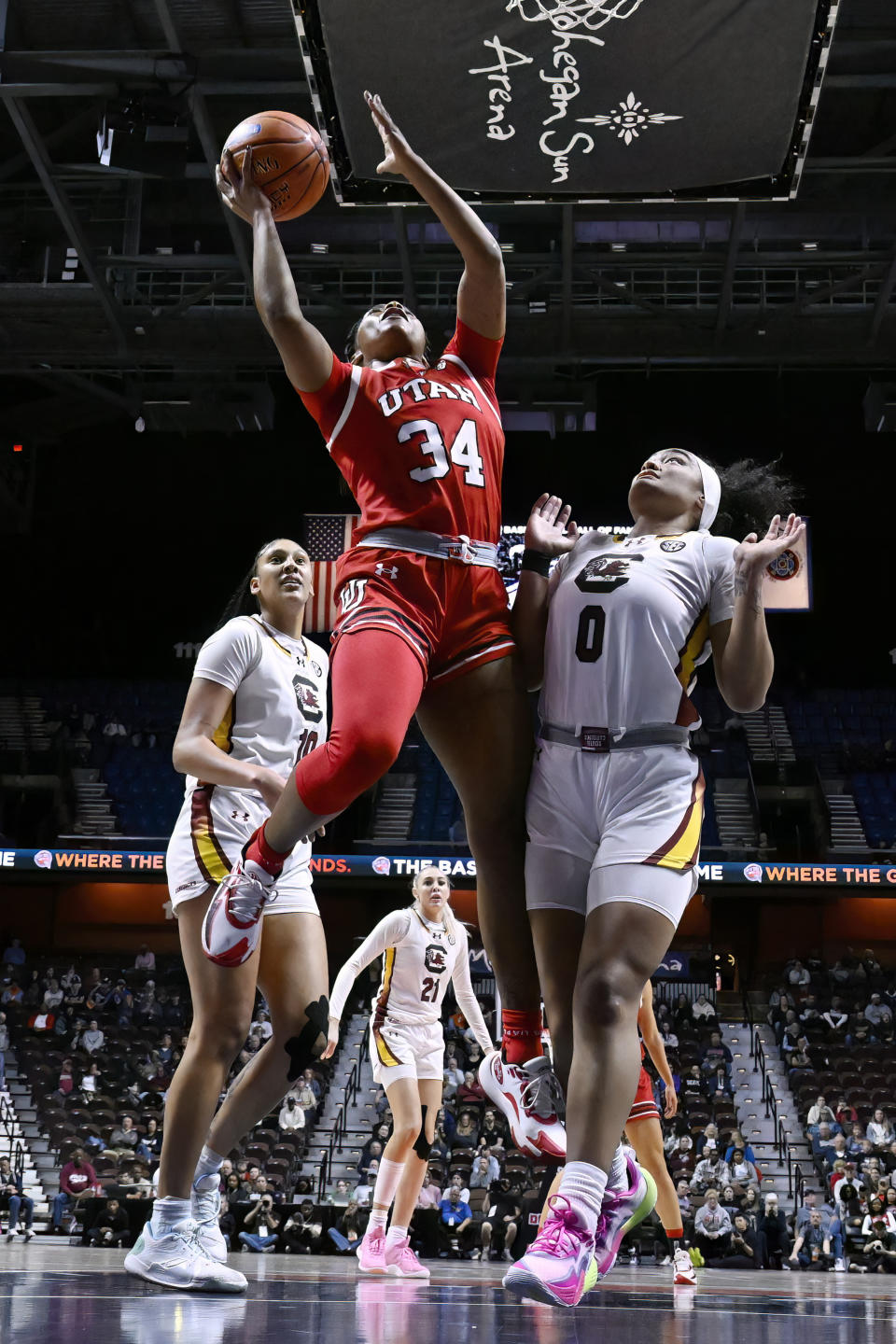 Utah forward Dasia Young (34) shoots over South Carolina guard Te-Hina Paopao (0) in the first half of an NCAA college basketball game, Sunday, Dec. 10, 2023, in Uncasville, Conn. (AP Photo/Jessica Hill)