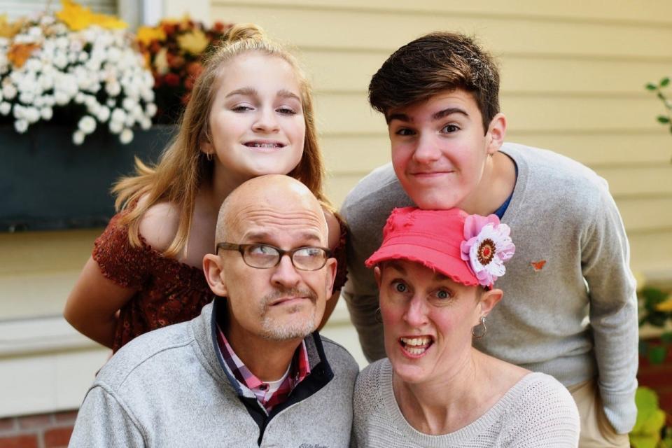 Thomas and Polly Fuller, and their children, Annie and Grady, have a little fun while posing for a family portrait.