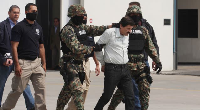 Joaquin 'El Chapo' Guzman is escorted to a helicopter in handcuffs by Mexican navy marines. Guzman leader of Mexico's Sinaloa drug Cartel, was captured alive overnight in the beach resort town of Mazatlan, considered the Mexican most-wanted drug dealer on February 22, 2014 in Mexico City, Mexico. Photo: Getty Images