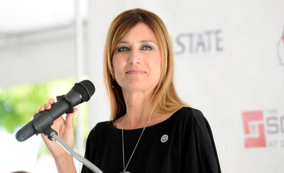 Debbie Astone, Associate Vice President and Executive Director of Auxiliary Services at Fresno State, gives the welcome message during the grand opening of The Square at Campus Pointe Friday, July 17, 2015.