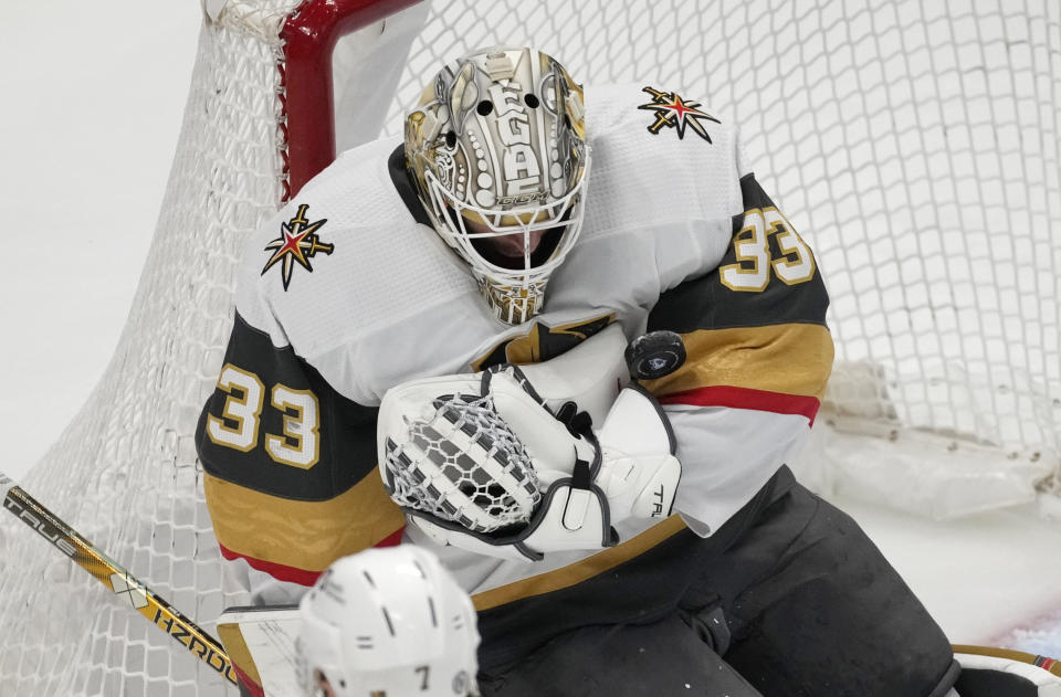 Vegas Golden Knights goaltender Adin Hill stops a shot in the first period of an NHL hockey game against the Colorado Avalanche, Monday, Feb. 27, 2023, in Denver. (AP Photo/David Zalubowski)