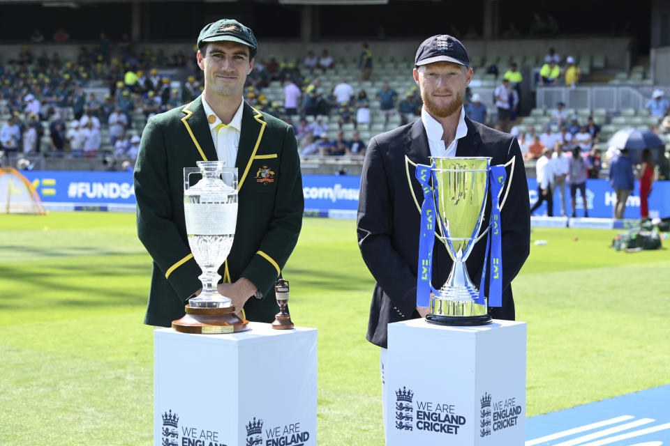 Pat Cummins of Australia, left, and Ben Stokes of England pose for a photo with the The Ashes urn and series trophies prior to Day One of the LV= Insurance Ashes 1st Test match between England and Australia at Edgbaston in Birmingham, Britain, Friday June 16, 2023. (Stu Forster/Getty Images via AP)