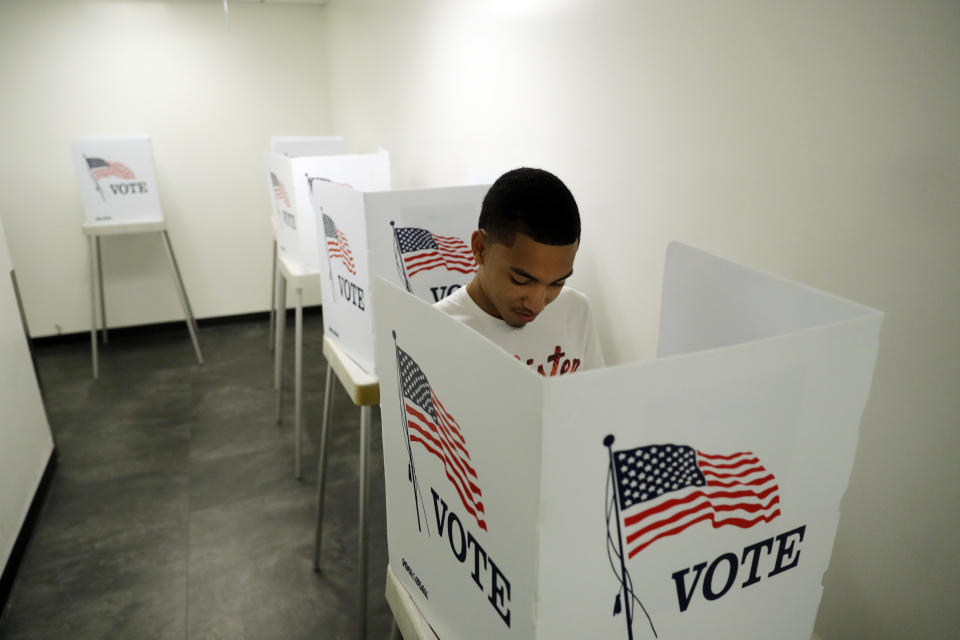 FILE - In this Oct. 23, 2018 file photo, Christian Goodman votes at the Los Angeles County Registrar of Voters office, Oct. 23, 2018, in Norwalk, Calif. Democratic infighting is rattling elections in California swing districts that could be key to U.S. House control. Democrats are hoping to regain seats the party lost to the GOP in 2020 in the heavily Democratic state. But rival Democrats are trading attacks that could undercut the party's chances. (AP Photo/Marcio Jose Sanchez, File)