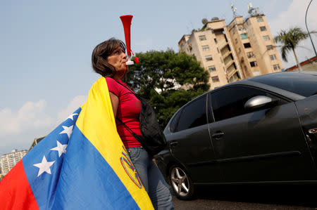 A supporter of Venezuelan opposition leader Juan Guaido, who many nations have recognized as the country's rightful interim ruler, takes part in a protest against Venezuelan President Nicolas Maduro's government in Caracas, Venezuela, April 10, 2019. REUTERS/Carlos Garcia Rawlins