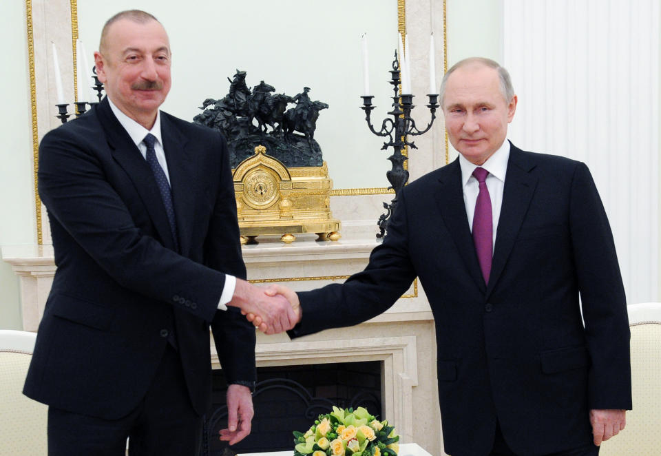 Russian President Vladimir Putin, right, shakes hands with Azerbaijan's President Ilham Aliyev, during their meeting in Kremlin in Moscow, Russia, Monday, Jan. 11, 2021. Russian President Vladimir Putin on Monday hosted his counterparts from Armenia and Azerbaijan, their first meeting since a Russia-brokered truce ended six weeks of fighting over Nagorno-Karabakh. (Mikhail Klimentyev, Sputnik, Kremlin Pool Photo via AP)