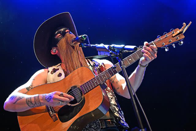 <p>Stephen J. Cohen/Getty Images</p> Orville Peck performs at Old Forester's Paristown Hall in April 2023 in Louisville, Kentucky