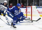 Toronto Maple Leafs defenseman Zach Bogosian (22) clears the puck while playing against the Winnipeg Jets during second period NHL hockey action in Toronto on Monday, Jan. 18, 2021. (Nathan Denette/The Canadian Press via AP)