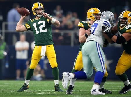 Jan 15, 2017; Arlington, TX, USA; Green Bay Packers quarterback Aaron Rodgers (12) throws a pass during the second quarter against the Dallas Cowboys in the NFC Divisional playoff game at AT&T Stadium. Mandatory Credit: Matthew Emmons-USA TODAY Sports