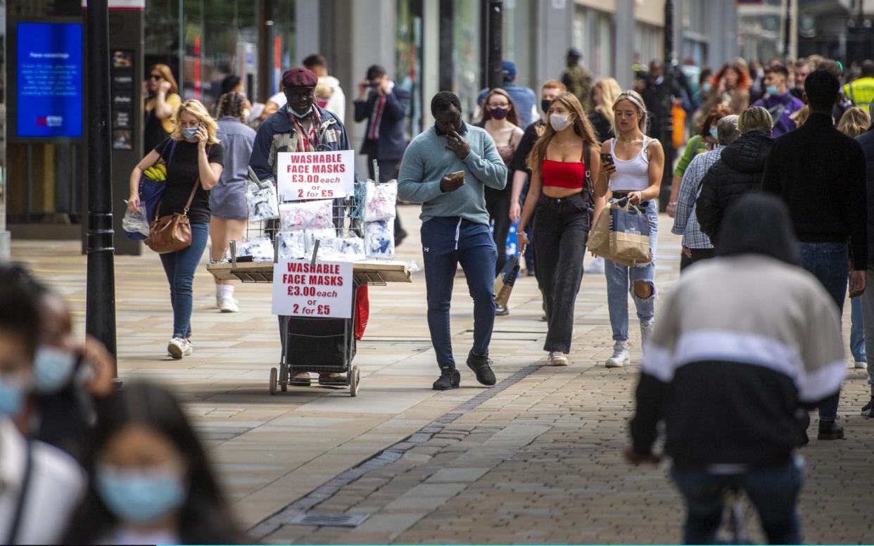A street vendor sells face masks on Market Street in Manchester, as people from different households in Greater Manchester, parts of East Lancashire and parts of West Yorkshire are banned from meeting each other indoors from midnight -  Anthony Devlin/Getty 