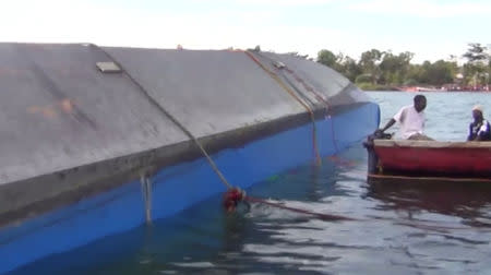 Rescue workers examine the hull of a ferry that overturned in Lake Victoria, Tanzania September 21, 2018, in this still image taken from video. Reuters TV/via REUTERS