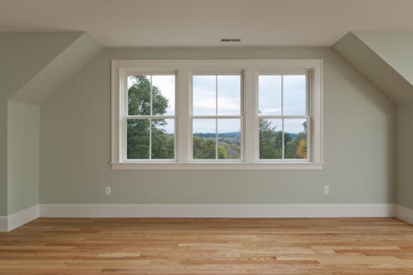 Master bedroom with view and hardwood floors.