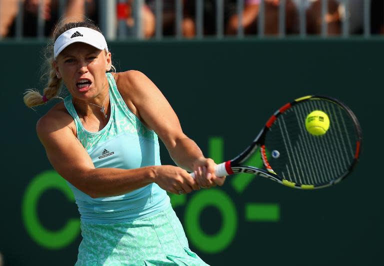 Caroline Wozniacki of Denmark plays a backhand against Madison Brengle during the Miami Open, at Crandon Park Tennis Center in Key Biscayne, Florida, on March 26, 2015