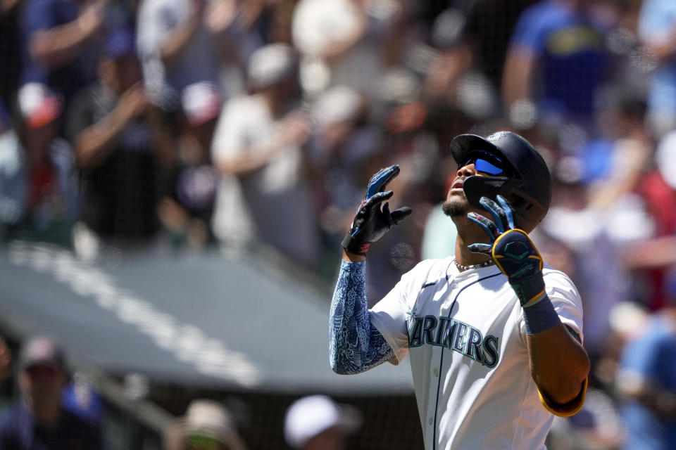 Seattle Mariners' Julio Rodríguez crosses home plate after hitting a solo home run against the Baltimore Orioles during the fifth inning of a baseball game Thursday, July 4, 2024, in Seattle. (AP Photo/Lindsey Wasson)