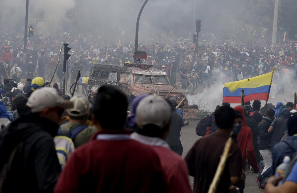 An armored vehicle drives towards a crowd of anti-government demonstrators protesting against President Lenin Moreno and his economic policies, in Quito, Ecuador, Tuesday, Oct. 8, 2019. The protests, which began when President Lenin Moreno’s decision to cut subsidies led to a sharp increase in fuel prices, have persisted for days and clashes led the president to move his besieged administration out of Quito. (AP Photo/Fernando Vergara)