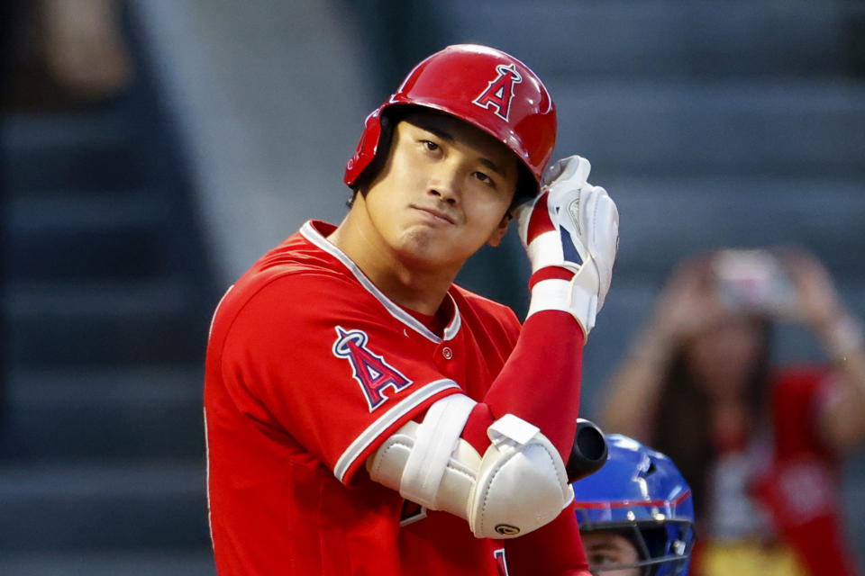 Los Angeles Angels' Shohei Ohtani checks his batting helmet during his at-bat in the first inning of the team's baseball game against the Texas Rangers in Anaheim, Calif., Saturday, Oct. 1, 2022. (AP Photo/Ringo H.W. Chiu)