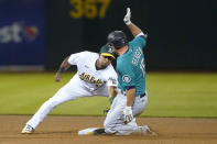 Seattle Mariners' Kyle Seager, right, is tagged out by Oakland Athletics shortstop Elvis Andrus trying to advance to second base on an RBI-single during the fifth inning of a baseball game in Oakland, Calif., Monday, Sept. 20, 2021. (AP Photo/Jeff Chiu)