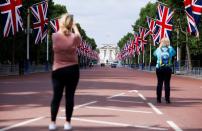 FILE PHOTO: People take photographs of Buckingham Palace and The Mall in London