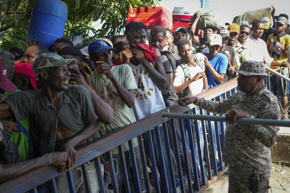 Haitians cross the border into Dajabon, Dominican Republic, Friday, May 17, 2024. As violence and political turmoil grip neighboring Haiti, the Dominican Republic will hold elections Sunday that have been defined by calls for more crackdowns on migrants and finishing a border wall dividing the countries. (AP Photo/Matias Delacroix)