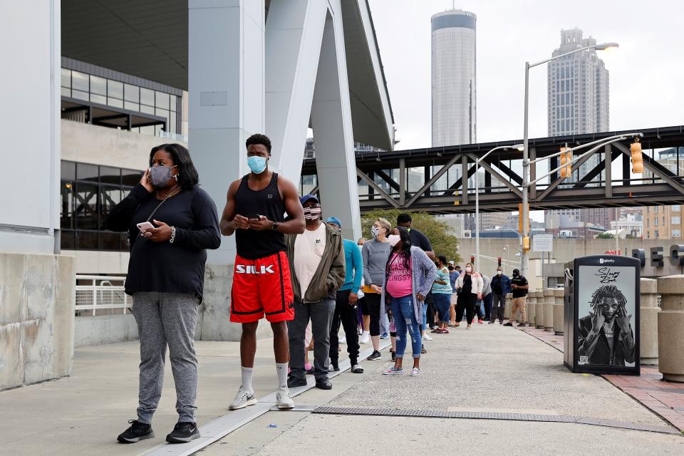 People line up to cast their ballots during early voting for the upcoming presidential elections outside of The Atlanta Hawks' State Farm Arena in Atlanta, Georgia, U.S., October 12, 2020.Chris Aluka Berry / Reuters