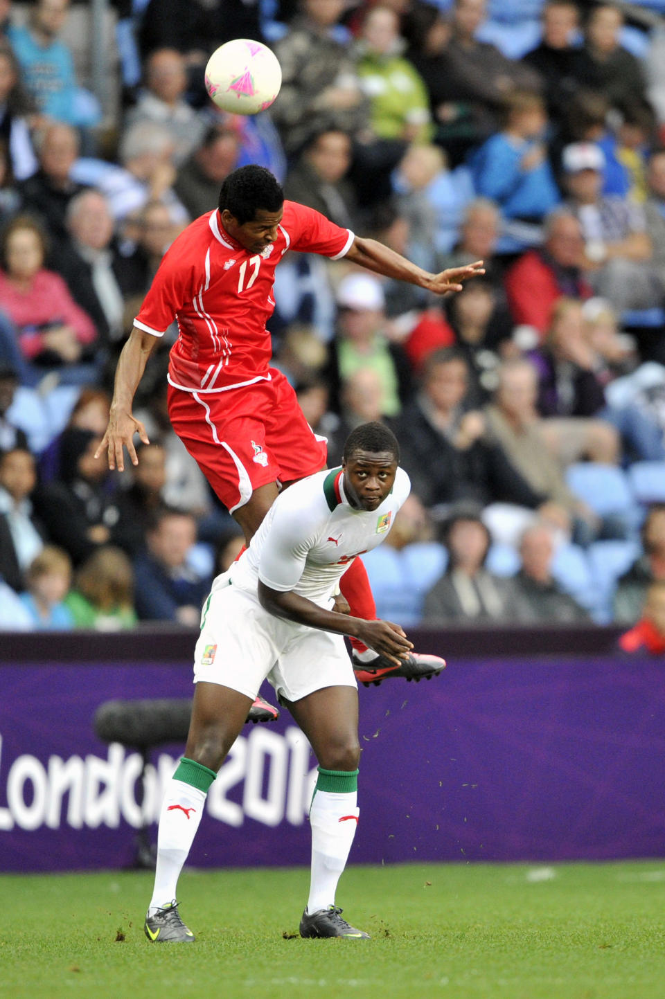 COVENTRY, UNITED KINGDOM - AUGUST 1: Mohamed Fawzi of United Arab Emirates heads the ball against Moussa Konate of Senegal during the Men's Football first round Group A Match between Senegal and United Arab Emirates, on Day 5 of the London 2012 Olympic Games at City of Coventry Stadium on August 1, 2012 in Coventry, England. (Photo by Francis Bompard/Getty Images)