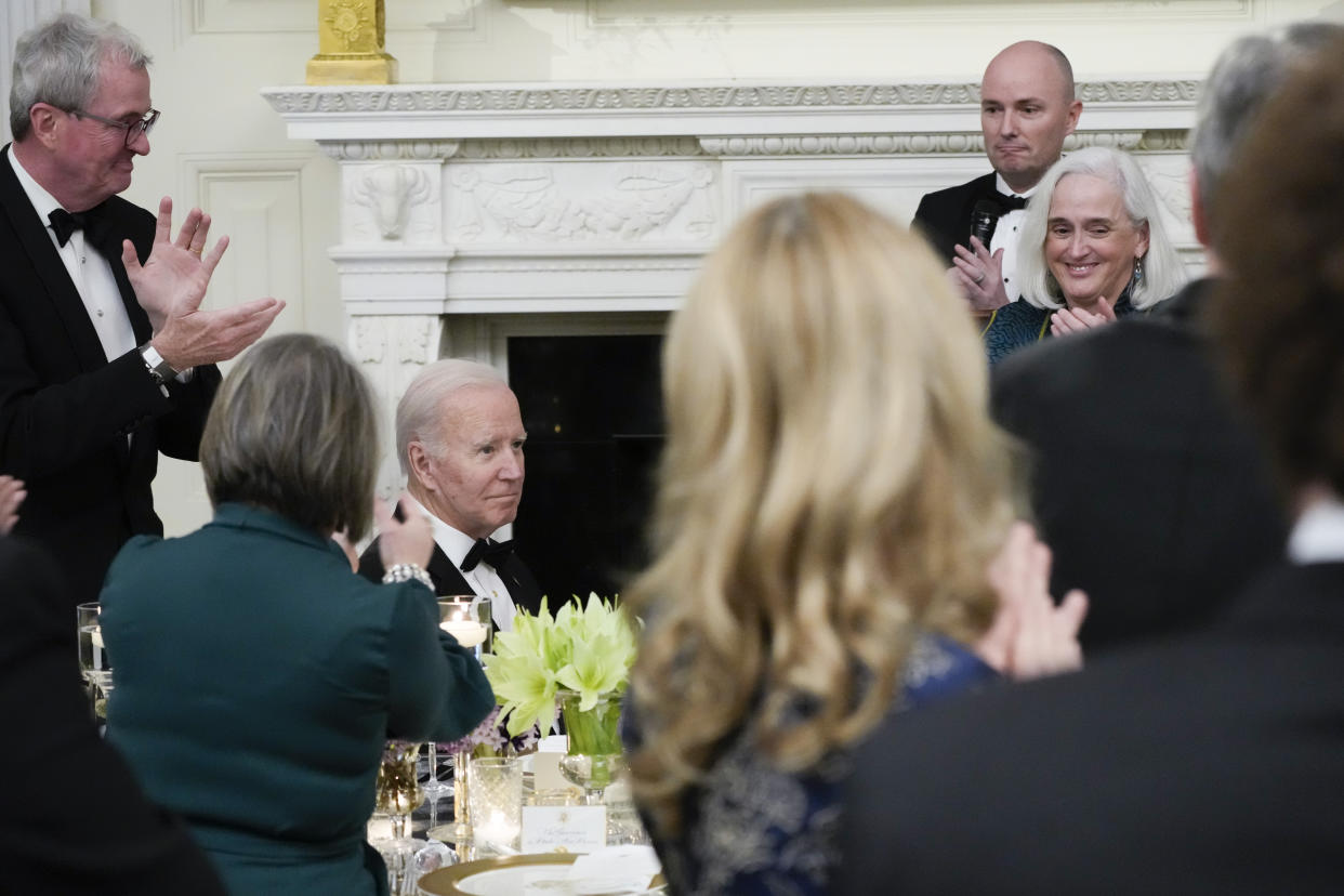 The National Governors Association Chair New Jersey Gov. Phil Murphy, left, National Governors Association Vice Chair Utah Gov. Spencer Cox and others applaud President Joe Biden during a dinner reception for governors and their spouses in the State Dining Room of the White House, Saturday, Feb. 11, 2023, in Washington. (AP Photo/Manuel Balce Ceneta)