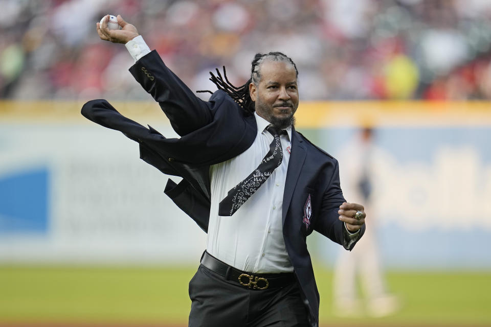 Former Cleveland baseball player Manny Ramirez throws out a ceremonial first pitch before a game between the Detroit Tigers and the Cleveland Guardians after being inducted into the Guardians Hall of Fame, Saturday, Aug. 19, 2023, in Cleveland. (AP Photo/Sue Ogrocki)