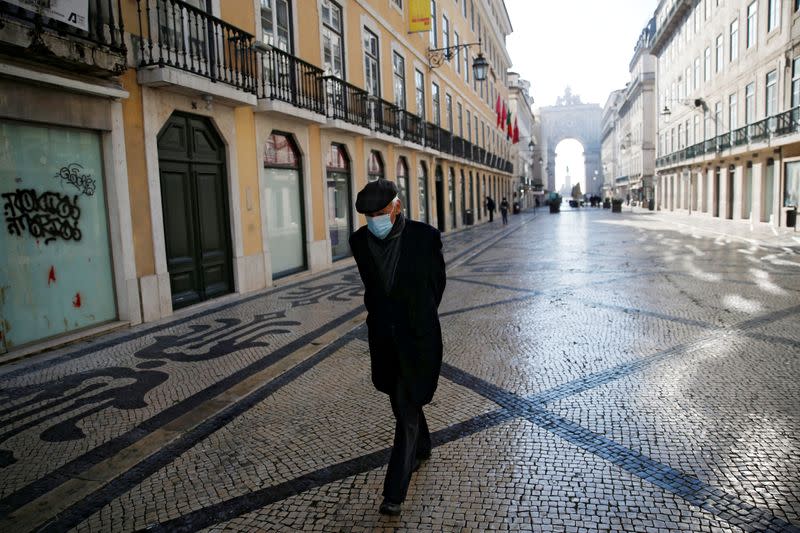 FILE PHOTO: A man waks in downtown Lisbon on the first day of the second national lockdown due to the coronavirus disease (COVID-19) pandemic in Lisbon